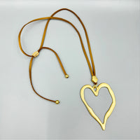 Open Heart Pendant Necklace - Silver with Black Cord, flat lay